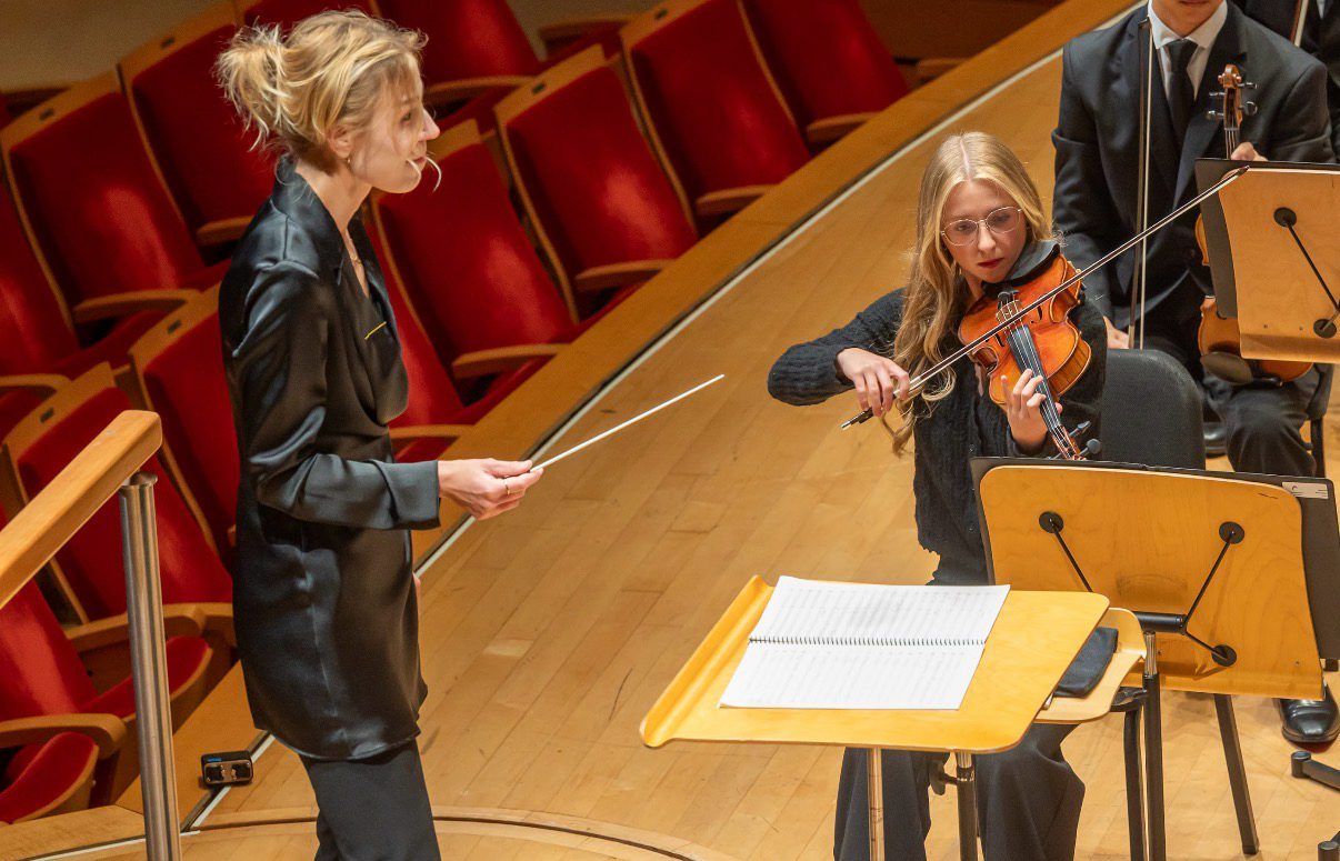 Hannah playing at the first stand, beside the conductor